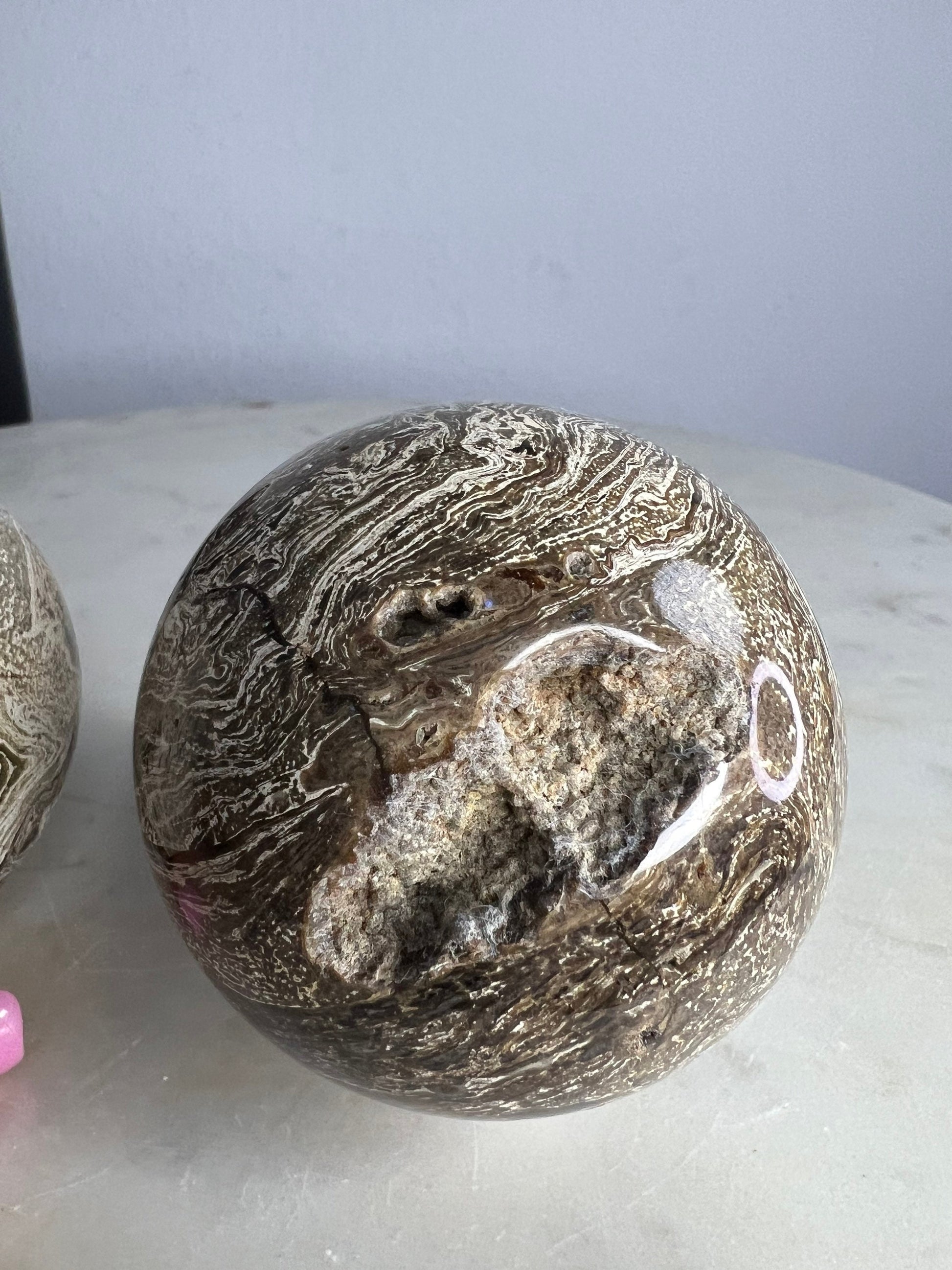 2 Petrified wood spheres from Madagascar. You will get the 2 in the picture total weight 1 pound 13oz .