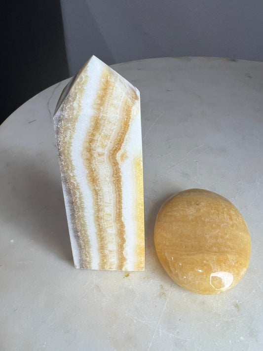 Banded orange calcite tower and palm total weight is 272grams you get both.