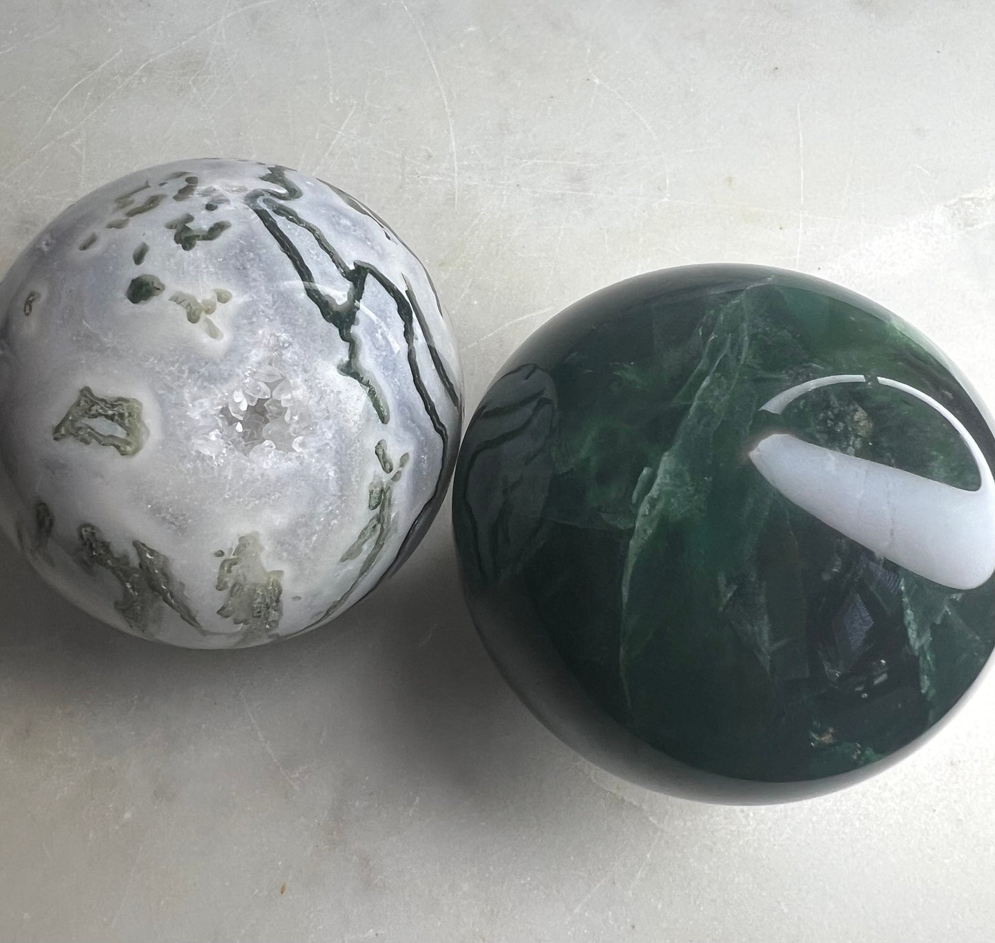 2 sphere set total weight 1pound 8oz. 1 moss agate and 1 dark green fluorite.