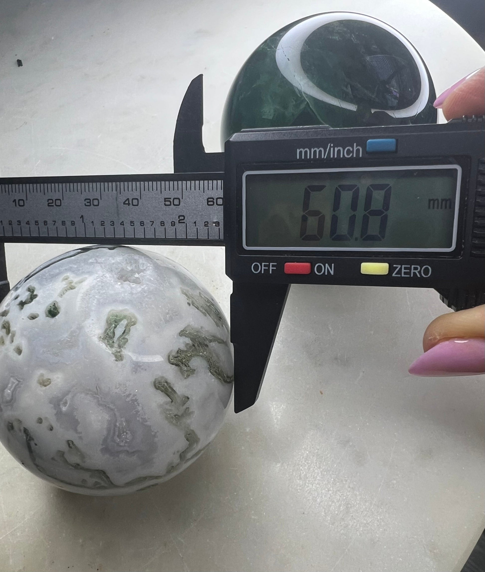 2 sphere set total weight 1pound 8oz. 1 moss agate and 1 dark green fluorite.